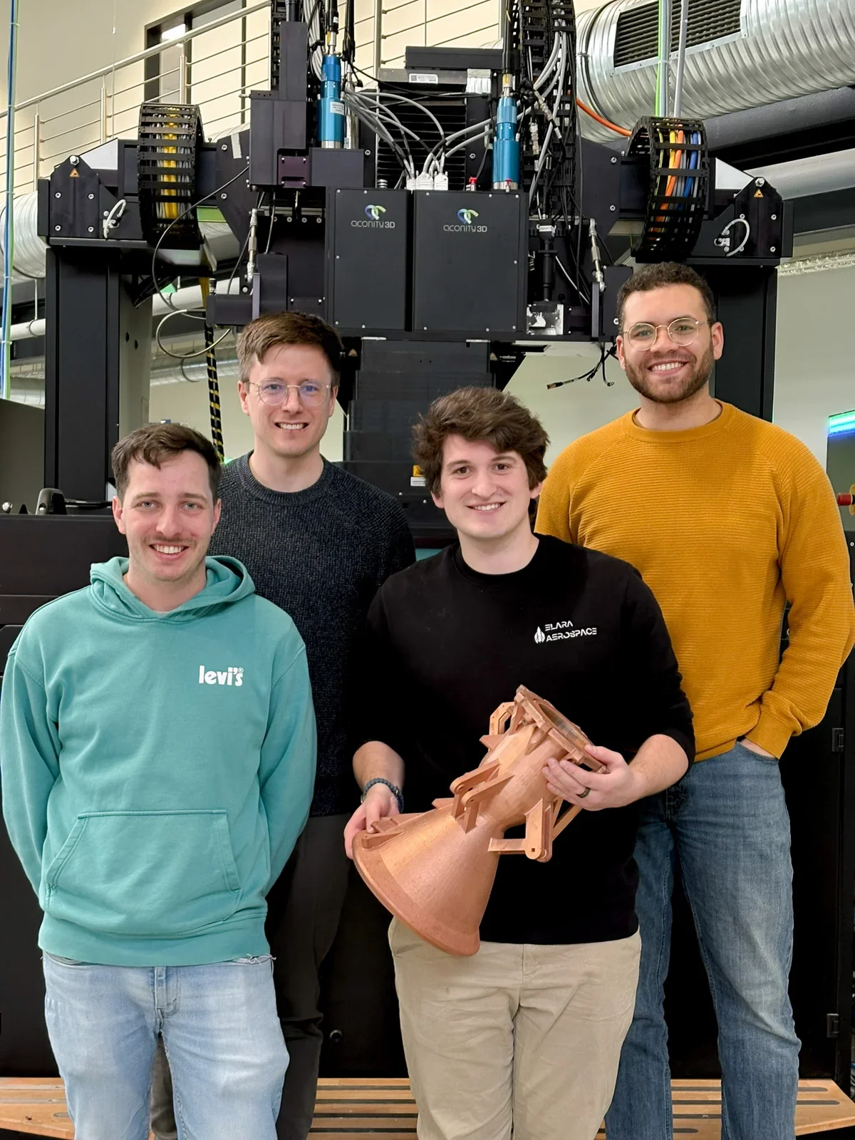 Elara engineers with a newly manufactured engine at Aconity3D